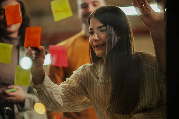 istock Young diverse business team brainstorming ideas on sticky notes 2246992201