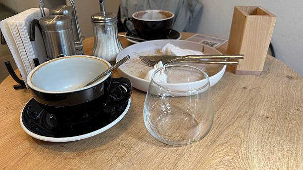 istock Coffee shop table with empty cups and crockery showcasing post-meal setting with utensils 2246992514