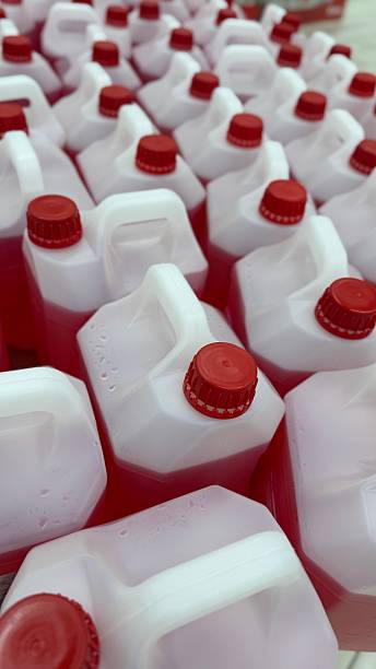 istock Plastic bottles with red liquid and caps arranged together. Ideal for a background image 2246992718