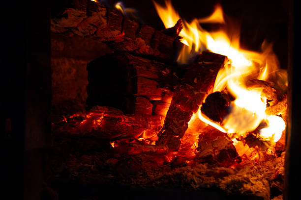 istock Flames rise and flicker, casting a warm glow as logs burn in the fireplace during a cold evening gathering 2246995294