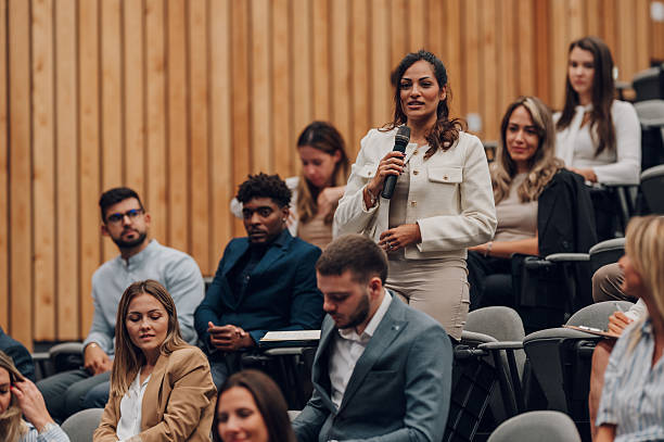 istock Woman asking question during business conference 2247002062