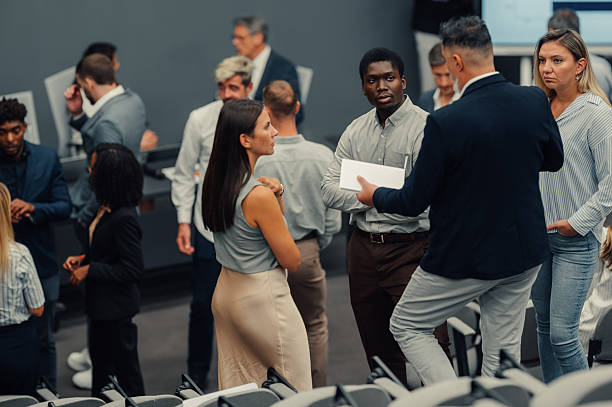 istock Business professionals networking and discussing at a conference 2247002484