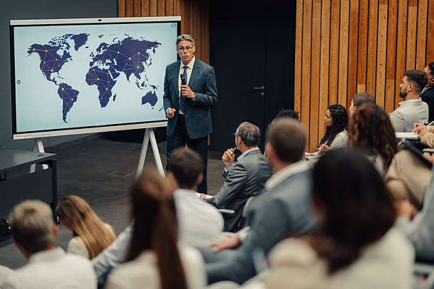 istock Speaker presenting global business strategy to audience 2247002592