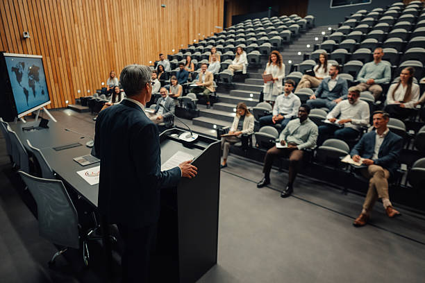 istock Speaker presenting global business strategy to diverse audience 2247002617