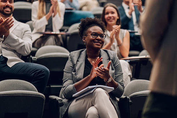 istock Audience members applauding presenter at business conference 2247002692