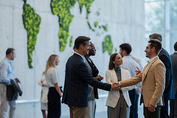 istock Business people shaking hands at corporate conference 2247004583