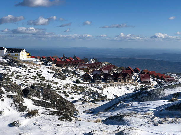 Snow-Covered Mountain Landscape with Wooden Cabins in Serra da Estrela
