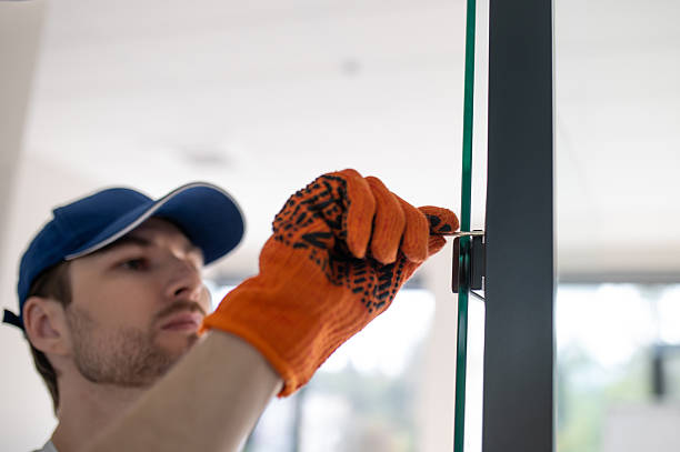 istock Craftsman installing hardware on glass door or partition 2247011762