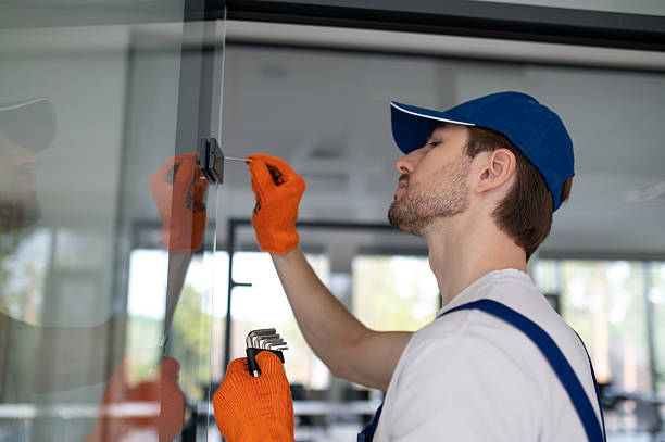 istock Worker fitting handles and locks on glass partition 2247011770