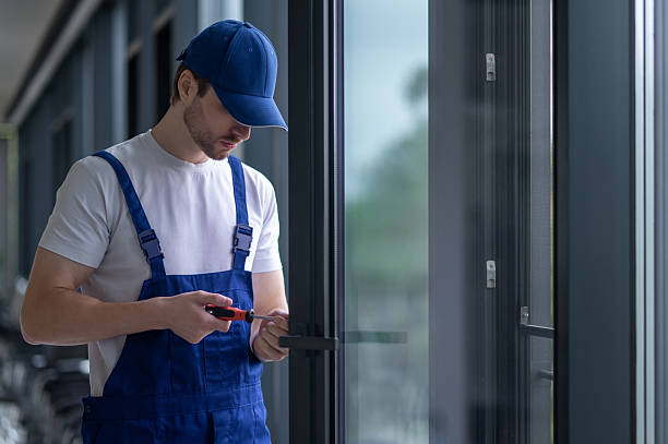 istock Craftsman installing hardware on glass door or partition 2247011815