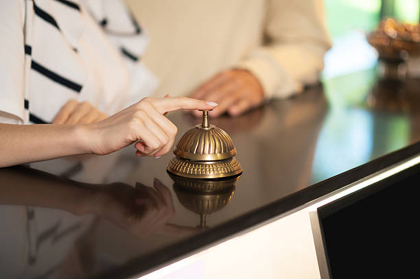 istock Close up picture of a hand ringing a reception bell 2247012359