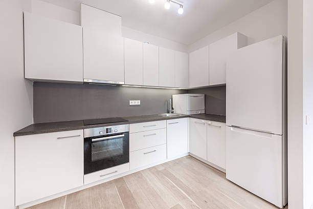 istock Modern Home Minimalist Kitchen Design With White Cabinets and Black Countertop 2247014685