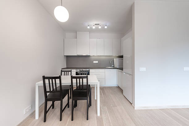 istock Modern Home Minimalist Kitchen with White Cabinets and Elegant Dining Furniture 2247014792