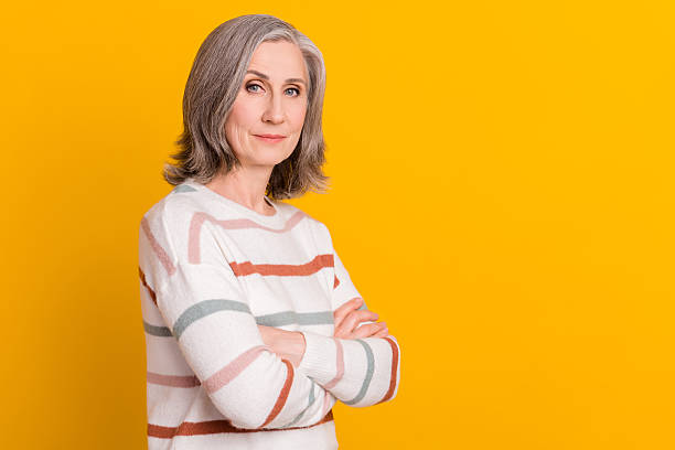 istock Profile side view portrait of attractive grey-haired woman folded arms copy blank space isolated over bright yellow color background 2247015675