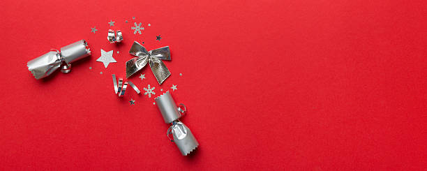 istock Christmas crackers with shiny confetti on color background, top view, copy space 2247016764