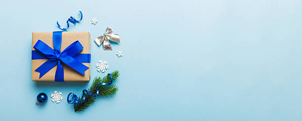 istock Top view Flat lay Christmas decorations and gift box on colored background with copy space. Christmas or Happy New Year composition 2247016912