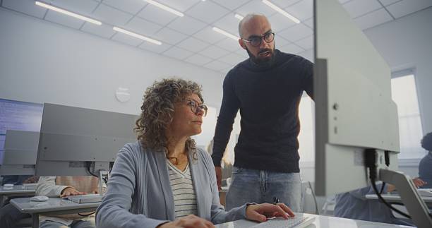 istock Diverse Mature Students Practice Digital Skills Under Male Teachers Supervision 2247017228