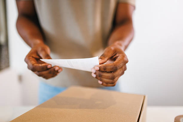 istock Hispanic Store Owner Checks Receipt in Shop 2247021507