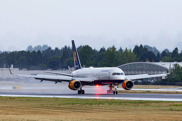 Portland, Oregon, USA - August 6, 2025: An Icelandair Boeing 757, direct from Reykjavík, lands on a wet runway at Portland International Airport.