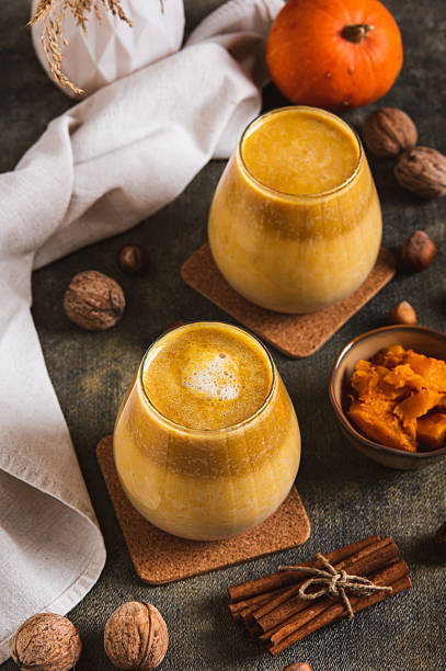 istock Autumn latte with pumpkin puree, nuts and cinnamon in glasses on the table vertical view 2247023637