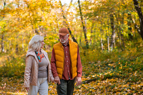 istock Happy retired couple walking in nature 2247024084