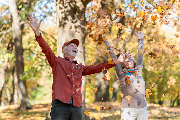 istock Senior couple throwing autumn leaves 2247024647