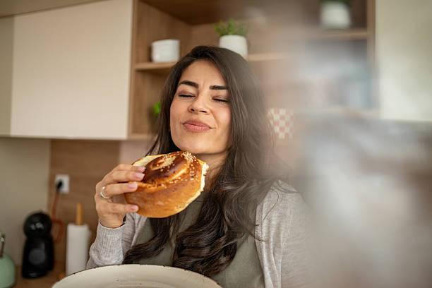 istock Woman enjoying fresh baked pastry in kitchen 2247025429