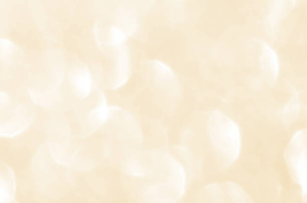 istock Golden yellow beige cream and white light glitter bokeh texture background. 2247027040