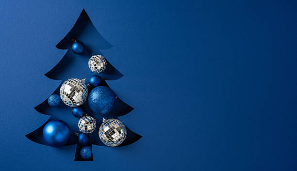 istock A stylized blue Christmas tree silhouette features shiny disco ball ornaments and glittering baubles, creating a modern festive mood perfect for holiday greeting campaigns and marketing appeals 2247028499