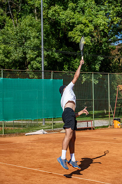 istock Tennis Player Practicing Powerful Serve on Clay Court 2247028833