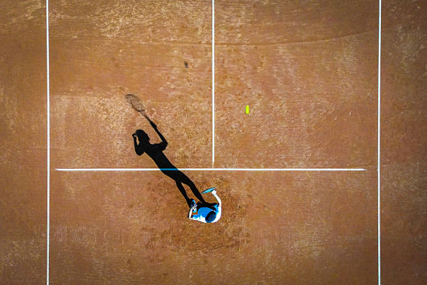 istock Silhouette of Tennis Player Practicing on Clay Court 2247028848