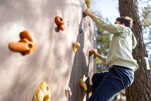istock Teenager boy climbing a rock wall 2247030375