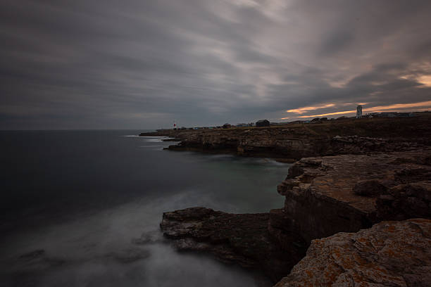 Evening descends upon Portland Bill Lighthouse on hate Dorset coast, UK. Composite image.
