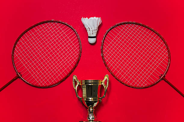 istock Two Red Badminton Rackets Flanking A White Shuttlecock Above A Golden Trophy 2247031914