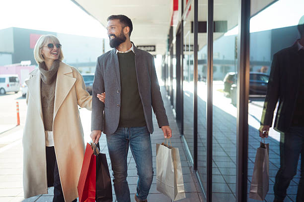 istock A fashionable couple standing close, browsing a retail display with joyful expressions 2247034711