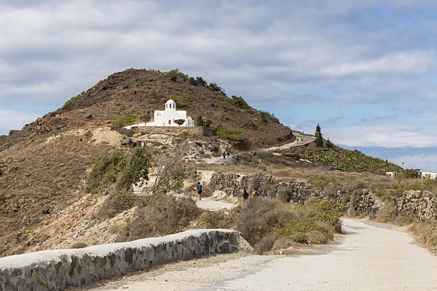 Traditional White Greek Church on Arid Volcanic Hillside in Santorini, Greece. 6 October 2025
