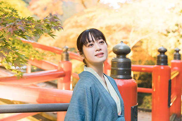 istock A woman strolling through the hot spring town at night(High-sensitivity night photography) 2247036751