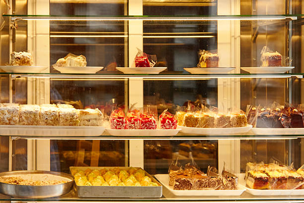 istock Display case filled with assorted desserts, showcasing colorful pastries, cakes, and sweets, inviting customers to indulge in delightful treats 2247039808