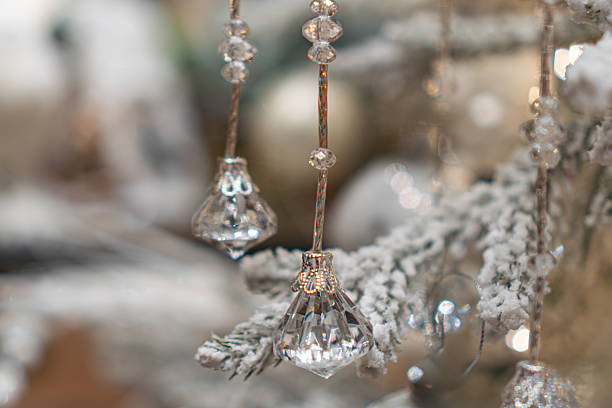 istock Close-up view of a meticulously arranged Christmas tree with various ornaments, predominantly silver, white, and clear crystals Soft, diffused lighting highlights the delicate branches and decoratio 2247041636