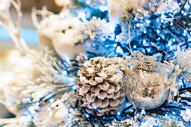 istock A luxurious, silver-toned Christmas tree features a central metallic sphere ornament within a clear bubble cover, surrounded by smaller snowflake and intricate decorations The 2247041688