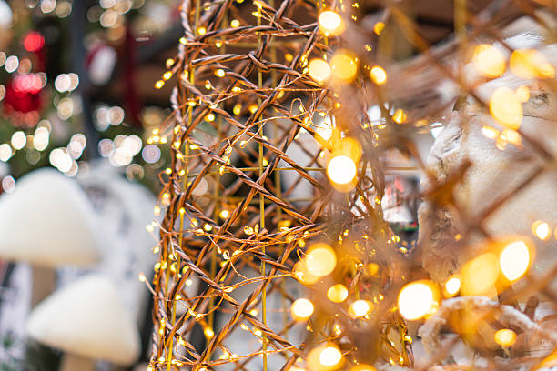 istock Festive scene with a lit metallic structure, decorative lights, Christmas tree, and New Years decorations n 2247042203