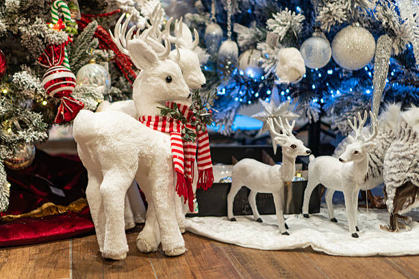 istock Christmas tree, decorations blue, silver, gold, shimmering ornaments, plush reindeer figurines, vibrant red and white stripes, warm lighting, soft shadows, low angle perspective, Christmas stocking 2247042307