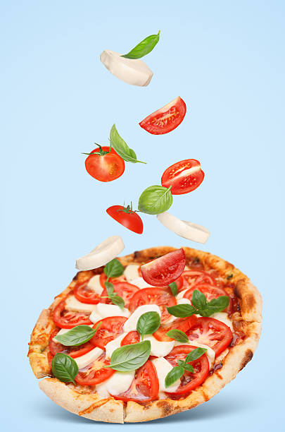 istock Caprese pizza and ingredients in air on light blue background 2247043202