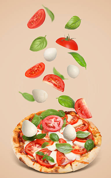 istock Caprese pizza and ingredients in air on dark beige background 2247043237