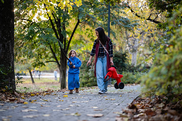 istock Mother and child walking in autumn park 2247044671