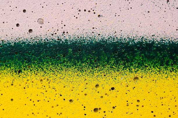 A close-up of a weathered wall featuring a textured surface with yellow and white paint. The aged and distressed appearance makes it suitable for abstract backgrounds, design elements, or architectural projects.