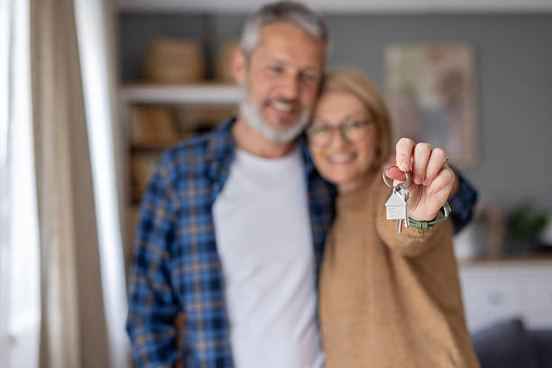 istock Happy couple holds keys, celebrating a new beginning 2247046795