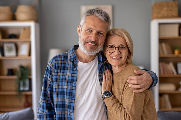 istock Senior couple smiling for the camera in their home 2247046801