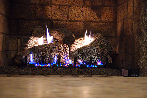 istock Cozy Fireplace With Logs And Blue Flames In Stone Setting For Home Ambiance 2247049213