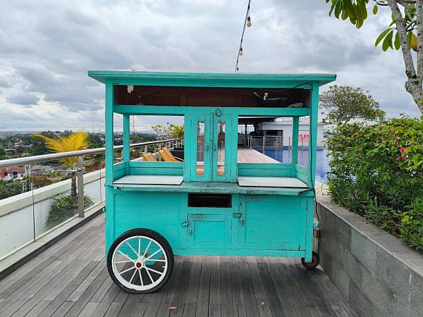 istock Turquoise Wooden Cart on a Rooftop Deck with City View 2247057580